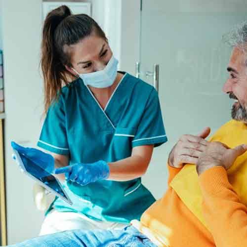 a woman touching her jaw due to failed dental implant