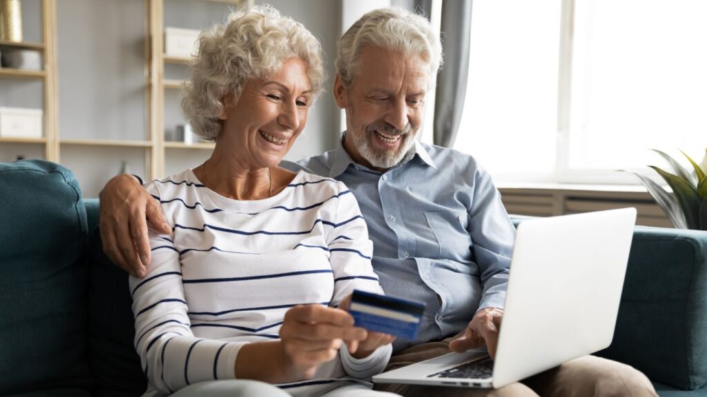 A man and a woman paying bills